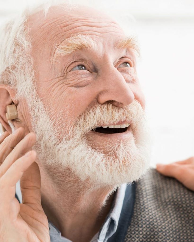 Senior Person Listening With Hearing Aid